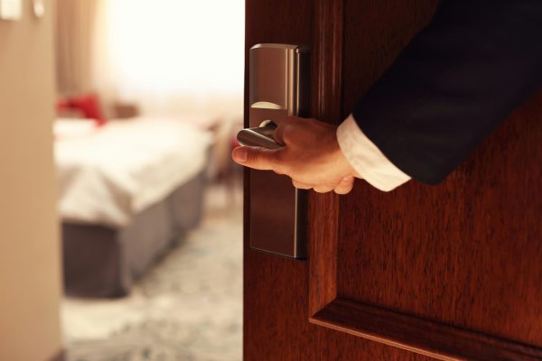 Hand of businessman opening hotel room